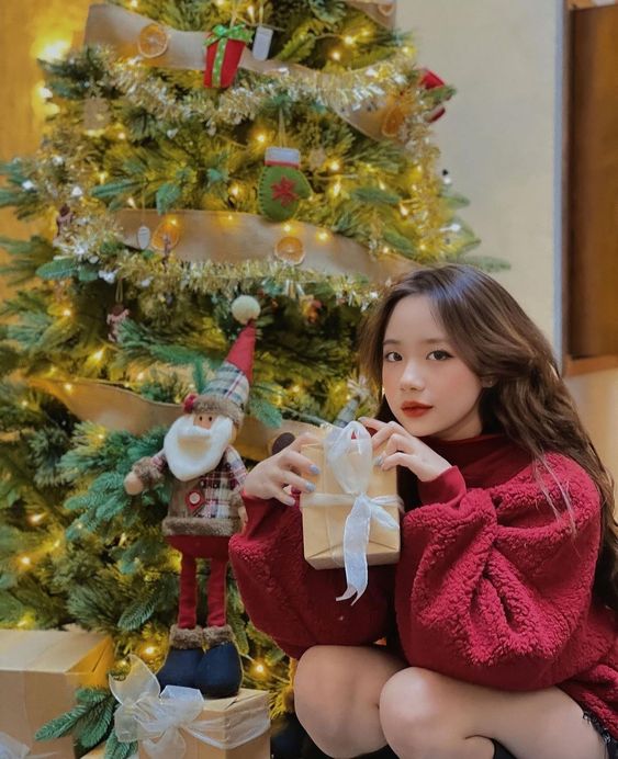 Tạo dáng ngồi với cây thông noel